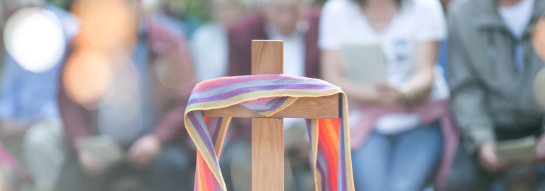 Holzkreuz mit buntem Tuch