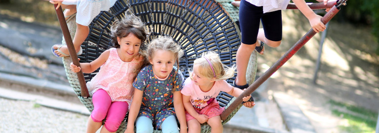 Kinder schaukeln gemeinsam auf einer großen Schaukel